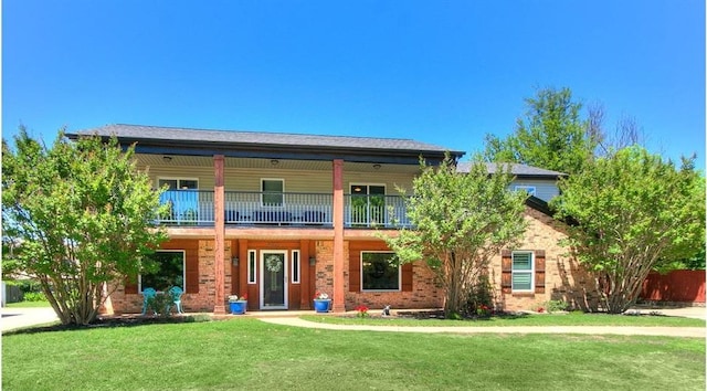 4303 Oxford Way, Norman, OK 73072 - view of front of property featuring a balcony, a front yard, and brick siding