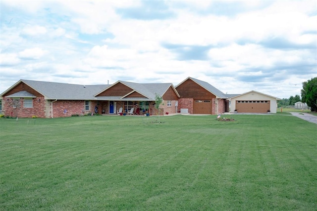8100 N Burns Rd, Edmond, OK 73025 - ranch-style house with a front lawn, brick siding, driveway, and an outdoor structure