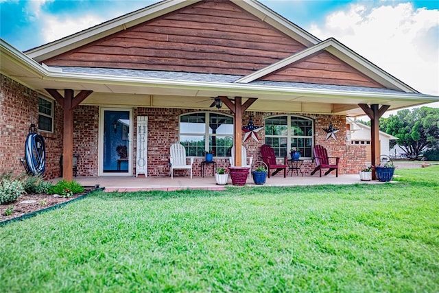 8100 N Burns Rd, Edmond, OK 73025 - view of front facade with a front yard, a ceiling fan, brick siding, and covered porch