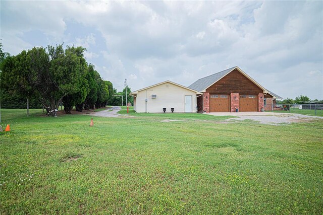 8100 N Burns Rd, Edmond, OK 73025 - view of property exterior with a garage, a yard, and brick siding