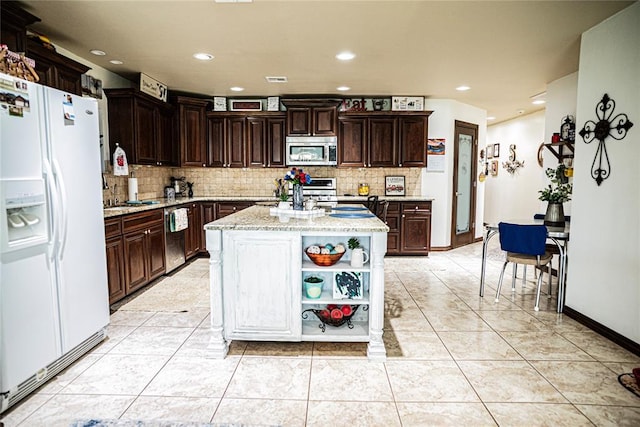 8100 N Burns Rd, Edmond, OK 73025 - kitchen with stainless steel appliances, open shelves, tasteful backsplash, light stone countertops, and dark brown cabinets