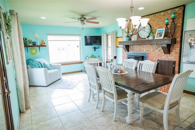 8100 N Burns Rd, Edmond, OK 73025 - tiled dining space with ceiling fan, a brick fireplace, a chandelier, baseboards, and recessed lighting