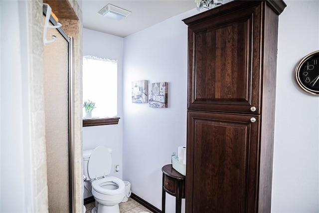 8100 N Burns Rd, Edmond, OK 73025 - bathroom featuring a shower stall, toilet, tile patterned flooring, and baseboards