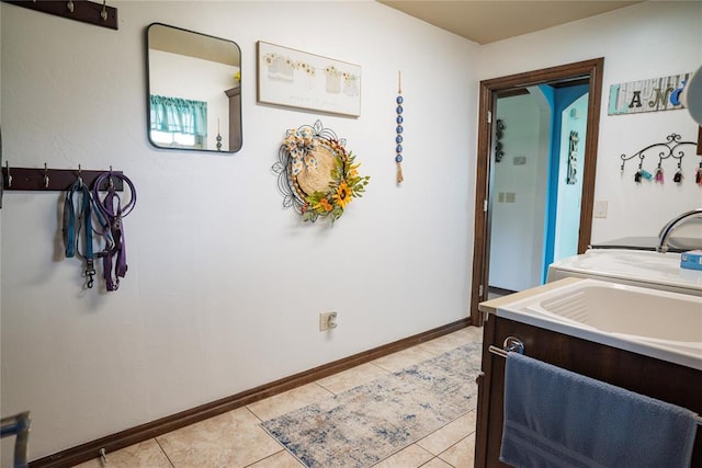 8100 N Burns Rd, Edmond, OK 73025 - kitchen with light tile patterned flooring, baseboards, light countertops, and a sink