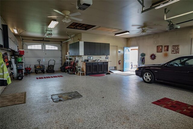 8100 N Burns Rd, Edmond, OK 73025 - garage with a garage door opener and ceiling fan