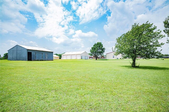 8100 N Burns Rd, Edmond, OK 73025 - view of grassy yard featuring a pole building and an outdoor structure