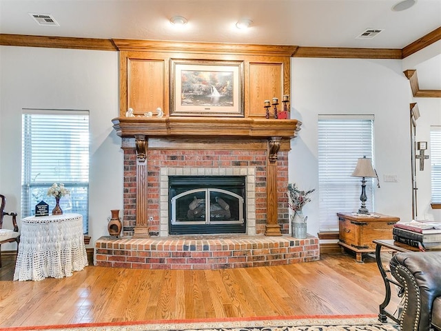 5877 W Washington Ave, Piedmont, OK 73078 - living area featuring crown molding, a brick fireplace, wood finished floors, and baseboards