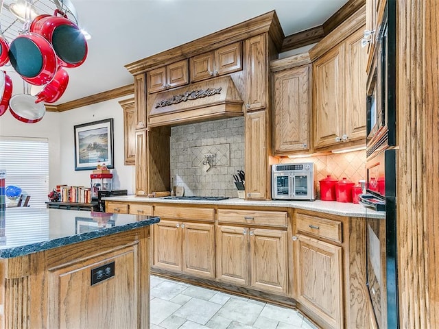 5877 W Washington Ave, Piedmont, OK 73078 - kitchen featuring ornamental molding, decorative backsplash, stainless steel gas cooktop, black oven, and custom exhaust hood