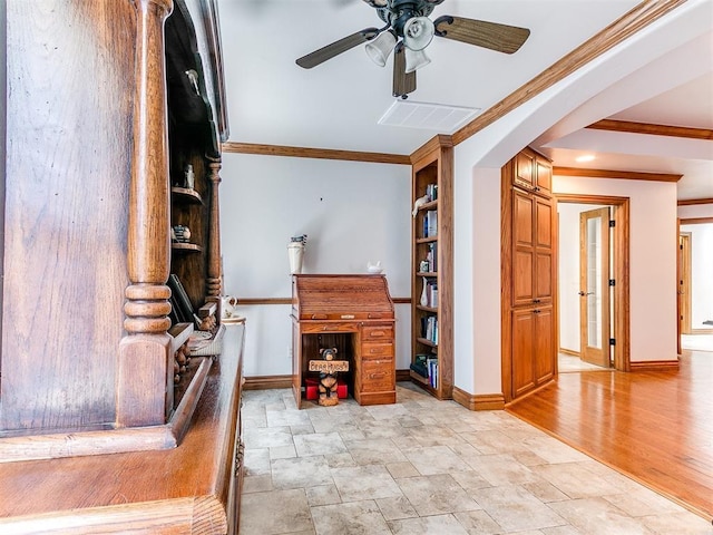 5877 W Washington Ave, Piedmont, OK 73078 - living room with crown molding, baseboards, stone finish floors, a ceiling fan, and arched walkways