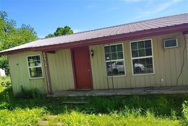 707 W 9th St, Kiowa, OK 74553 - property entrance featuring metal roof