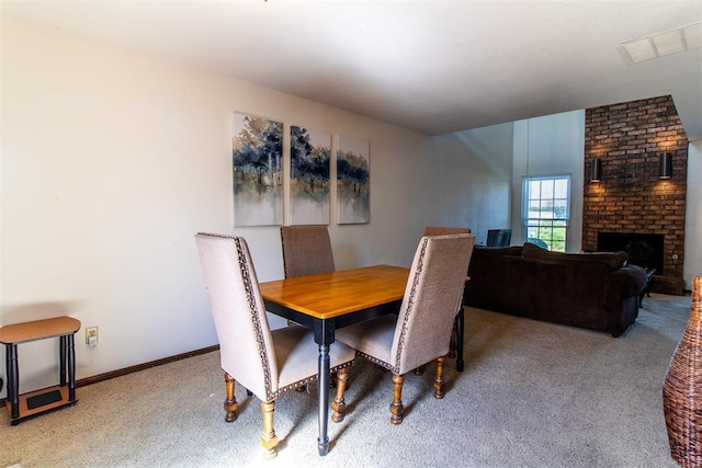 823 Two Forty Pl, Oklahoma City, OK 73139 - carpeted dining space featuring a fireplace and baseboards