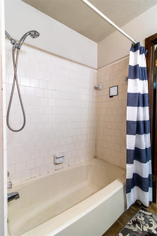 823 Two Forty Pl, Oklahoma City, OK 73139 - bathroom featuring shower / bath combo with shower curtain