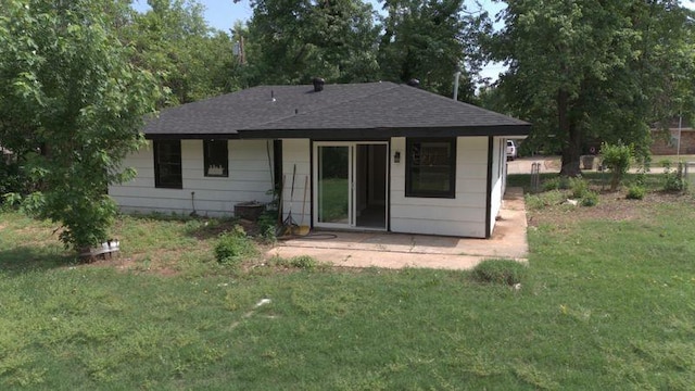 617 Holman Pl, Midwest City, OK 73110 - back of property with a yard, a patio, and a shingled roof