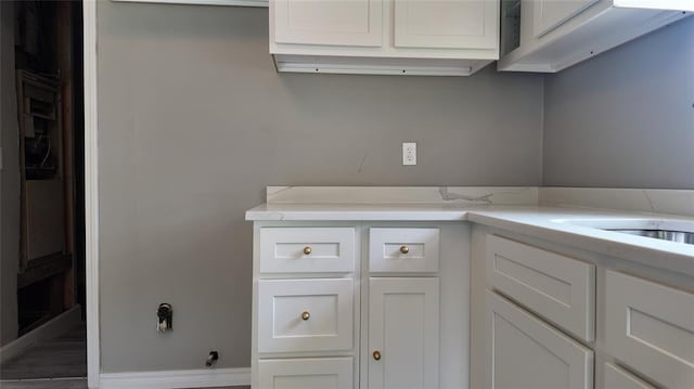 617 Holman Pl, Midwest City, OK 73110 - kitchen with white cabinetry and baseboards