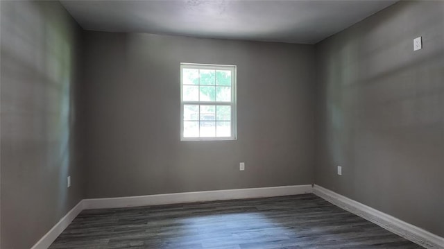 617 Holman Pl, Midwest City, OK 73110 - spare room featuring baseboards and dark wood finished floors