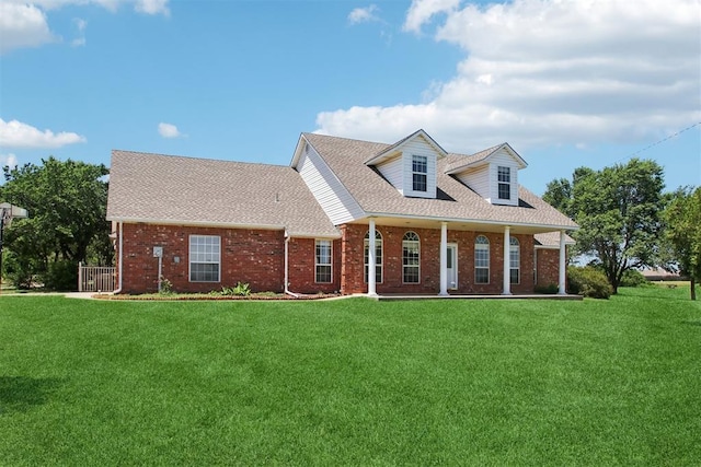 1227 Stout Dr NW, Piedmont, OK 73078 - cape cod-style house featuring a front yard, brick siding, and a shingled roof
