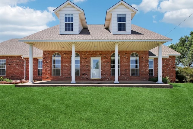 1227 Stout Dr NW, Piedmont, OK 73078 - back of house with a lawn, a shingled roof, brick siding, and covered porch