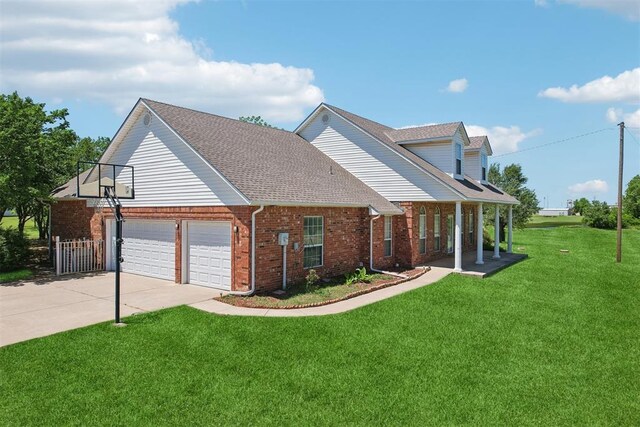 1227 Stout Dr NW, Piedmont, OK 73078 - traditional-style house featuring brick siding, a front yard, an attached garage, driveway, and covered porch