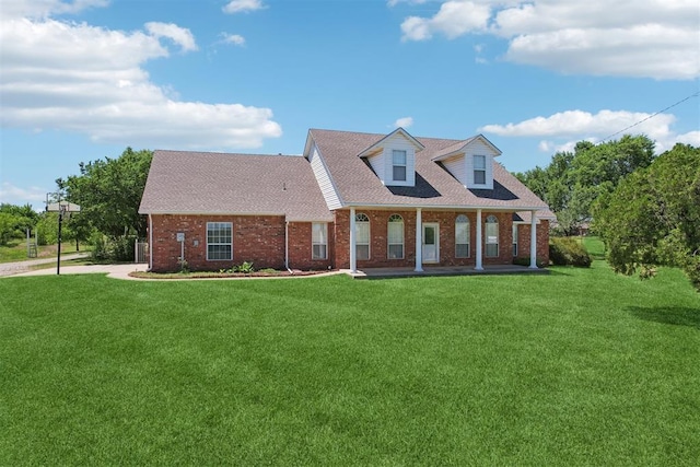 1227 Stout Dr NW, Piedmont, OK 73078 - cape cod-style house with brick siding, a front lawn, a porch, and a shingled roof