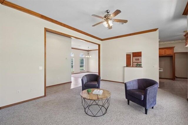 1227 Stout Dr NW, Piedmont, OK 73078 - sitting room featuring crown molding, light colored carpet, a ceiling fan, baseboards, and a chandelier