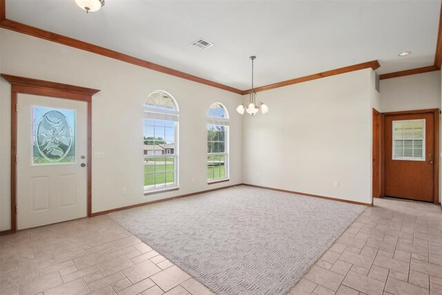 1227 Stout Dr NW, Piedmont, OK 73078 - foyer entrance with a chandelier, crown molding, and baseboards