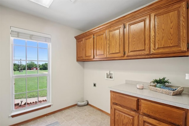1227 Stout Dr NW, Piedmont, OK 73078 - laundry area featuring cabinet space, electric dryer hookup, washer hookup, and baseboards