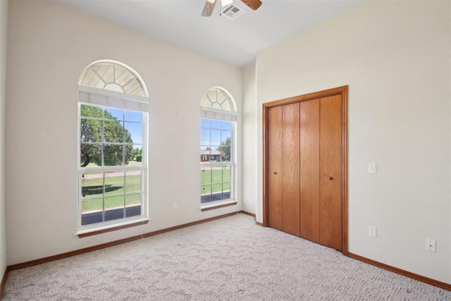 1227 Stout Dr NW, Piedmont, OK 73078 - unfurnished bedroom featuring carpet flooring, baseboards, a closet, and a ceiling fan