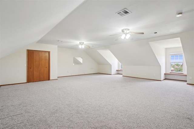 1227 Stout Dr NW, Piedmont, OK 73078 - bonus room featuring a ceiling fan, lofted ceiling, light carpet, and baseboards