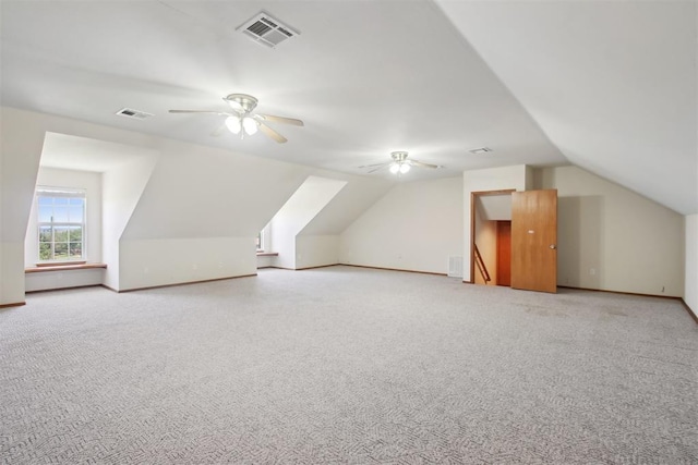1227 Stout Dr NW, Piedmont, OK 73078 - additional living space featuring lofted ceiling, a ceiling fan, light colored carpet, and baseboards