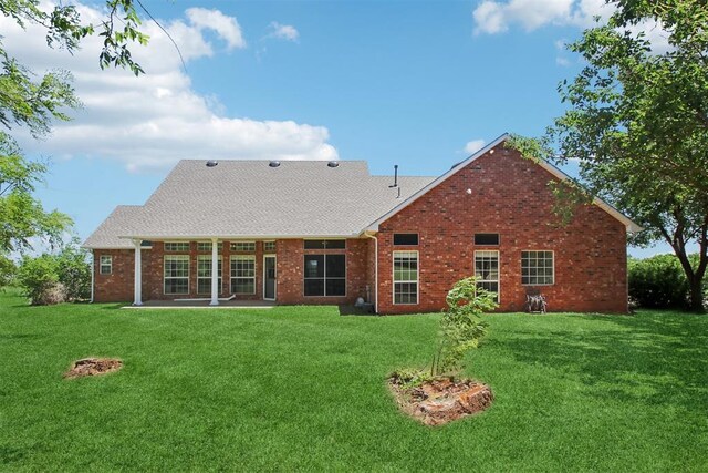 1227 Stout Dr NW, Piedmont, OK 73078 - rear view of property with brick siding, a lawn, a shingled roof, and a patio