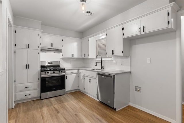 6 Utah Ave, Yukon, OK 73099 - kitchen featuring appliances with stainless steel finishes, under cabinet range hood, white cabinets, and a sink