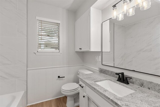 6 Utah Ave, Yukon, OK 73099 - full bathroom with wood finished floors, toilet, vanity, and a wainscoted wall