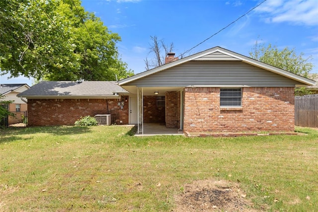 6 Utah Ave, Yukon, OK 73099 - rear view of property featuring brick siding, cooling unit, a patio area, and a chimney
