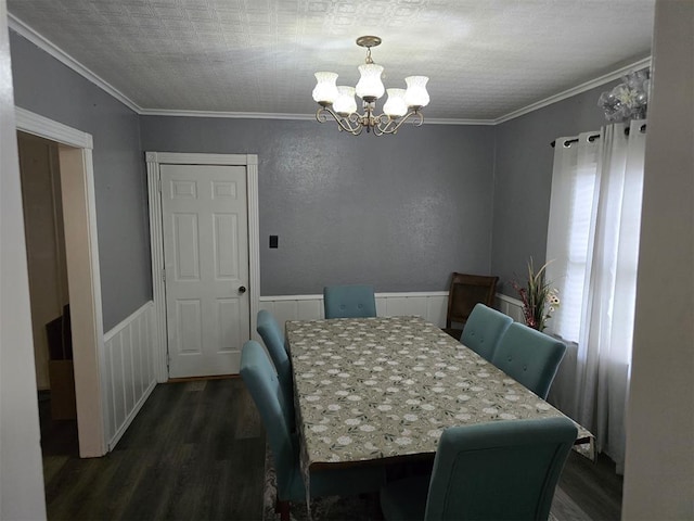 915 NW Euclid Ave, Lawton, OK 73507 - dining area with dark wood-style floors, a chandelier, a wainscoted wall, and crown molding