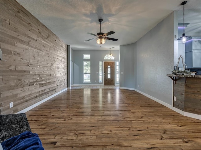 1900 New Haven Ct, Moore, OK 73160 - unfurnished living room featuring a ceiling fan, wood finished floors, and baseboards