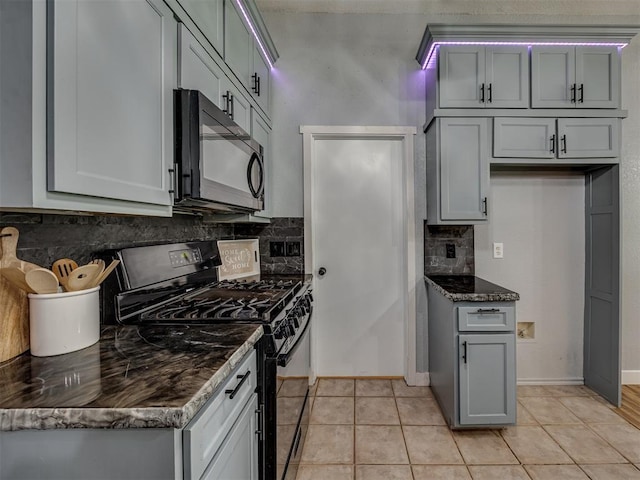 1900 New Haven Ct, Moore, OK 73160 - kitchen featuring black appliances, tasteful backsplash, light tile patterned flooring, and baseboards