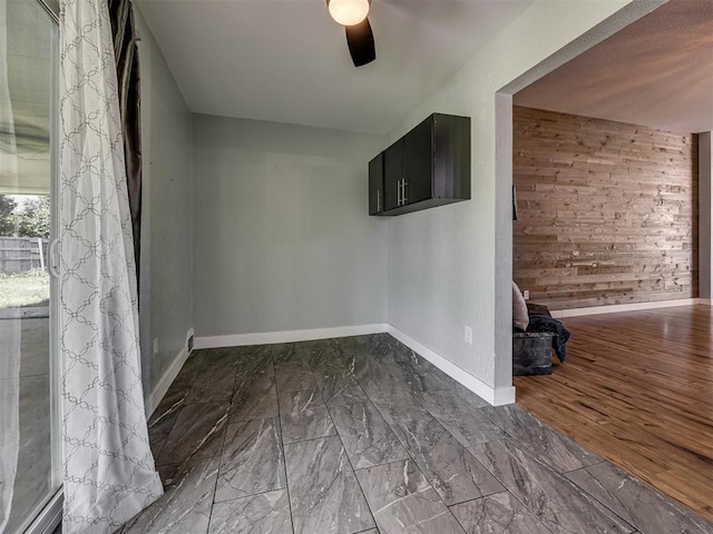 1900 New Haven Ct, Moore, OK 73160 - spare room with ceiling fan, baseboards, and wooden walls