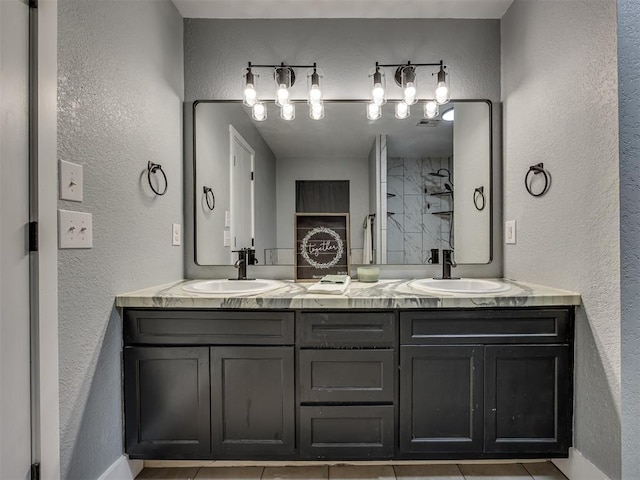 1900 New Haven Ct, Moore, OK 73160 - bathroom with double vanity, a textured wall, tile patterned flooring, a shower, and baseboards