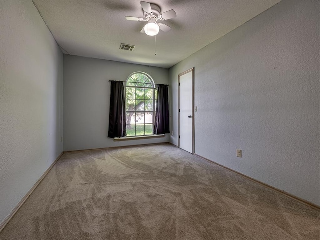 1900 New Haven Ct, Moore, OK 73160 - spare room with carpet flooring, a textured wall, a ceiling fan, baseboards, and a textured ceiling