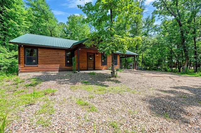 295 Orca Rd, Broken Bow, OK 74728 - chalet / cabin featuring covered porch, log veneer siding, a metal roof, and driveway