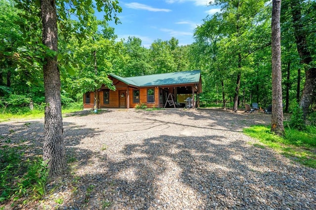 295 Orca Rd, Broken Bow, OK 74728 - chalet / cabin with driveway, a forest view, a porch, and a metal roof