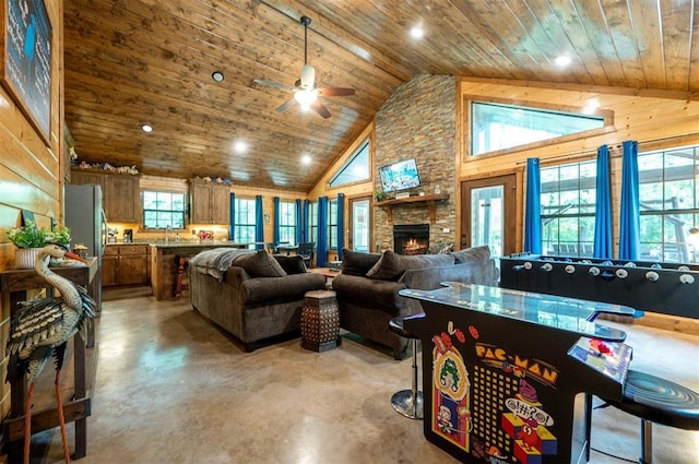 295 Orca Rd, Broken Bow, OK 74728 - living area featuring wooden ceiling, finished concrete flooring, ceiling fan, a fireplace, and high vaulted ceiling
