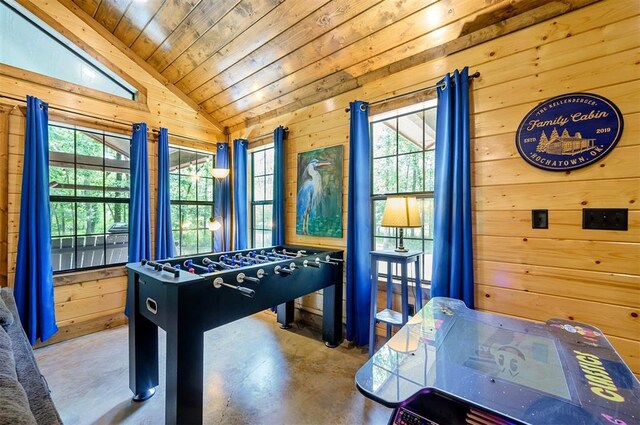 295 Orca Rd, Broken Bow, OK 74728 - game room with finished concrete flooring, vaulted ceiling, wooden walls, wood ceiling, and plenty of natural light