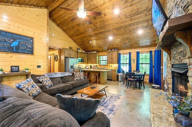 295 Orca Rd, Broken Bow, OK 74728 - living area with finished concrete flooring, wooden ceiling, wood walls, healthy amount of natural light, and high vaulted ceiling