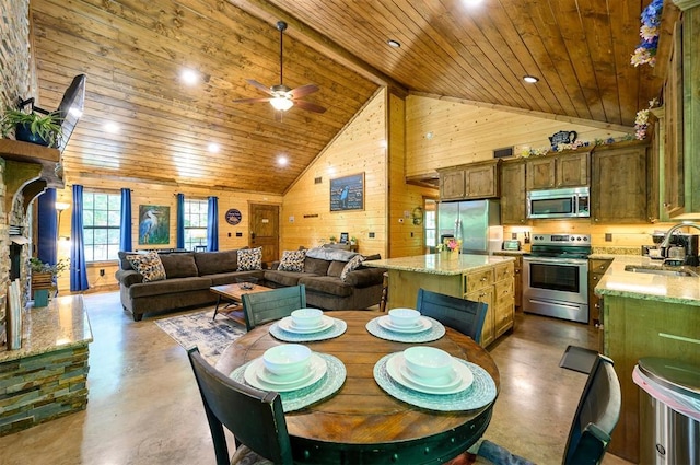295 Orca Rd, Broken Bow, OK 74728 - dining room with finished concrete floors, wooden ceiling, wooden walls, a ceiling fan, and high vaulted ceiling