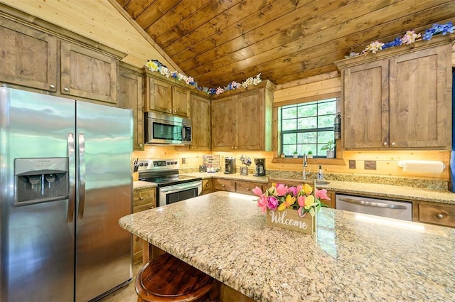 295 Orca Rd, Broken Bow, OK 74728 - kitchen with appliances with stainless steel finishes, wood ceiling, lofted ceiling, light stone countertops, and a kitchen breakfast bar
