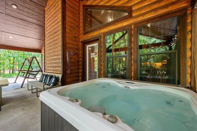 295 Orca Rd, Broken Bow, OK 74728 - misc room with a jacuzzi, carpet floors, and wood walls