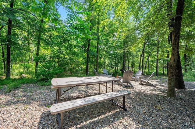 295 Orca Rd, Broken Bow, OK 74728 - surrounding community featuring a wooded view and a fire pit