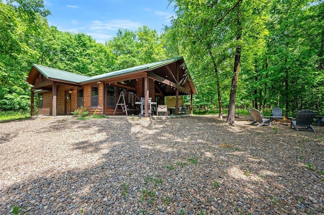 295 Orca Rd, Broken Bow, OK 74728 - rear view of property with an outdoor fire pit, a metal roof, and log veneer siding