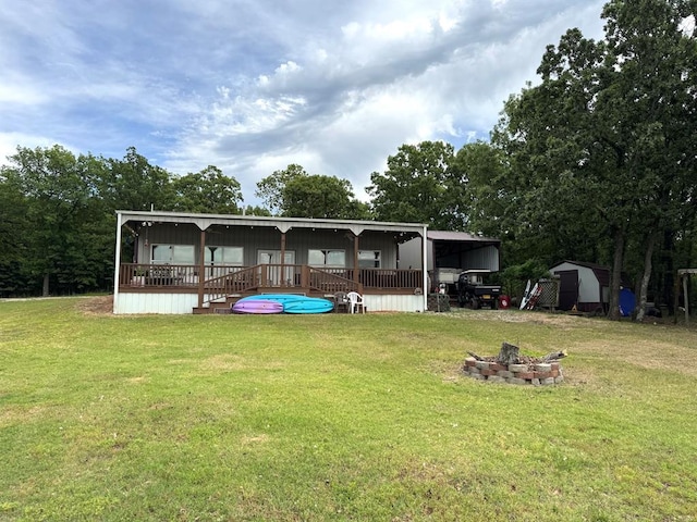 17308 Magnino Rd, Shawnee, OK 74801 - rear view of house featuring a fire pit and a lawn